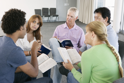 Group of people reading the Bible in a Bible Study group.