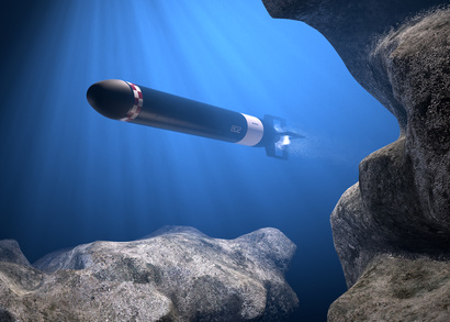 A submarine passing near the rocks in the deep blue sea.